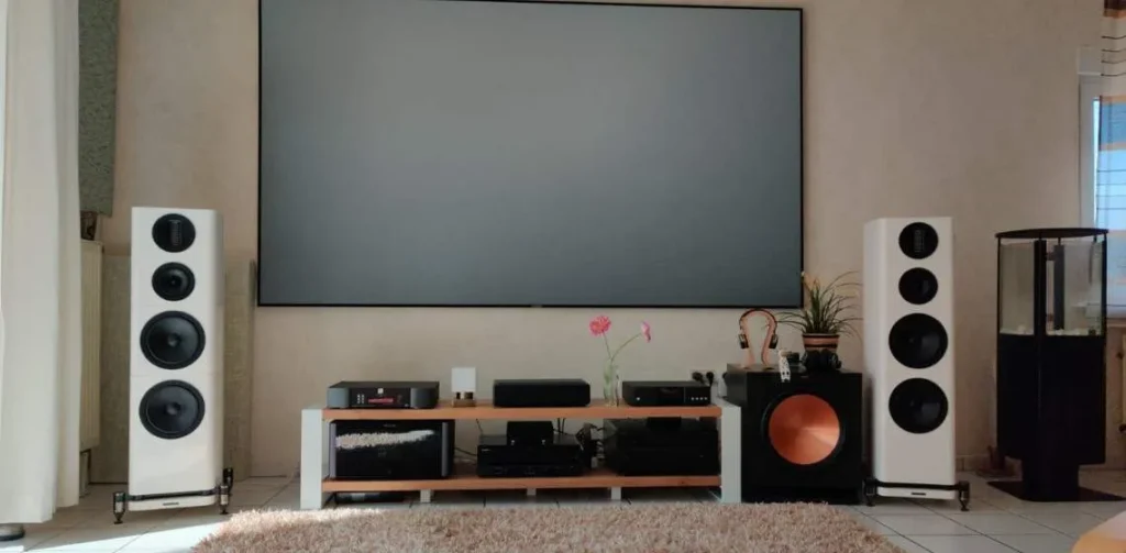 Wireless soundbar and surround speakers set up with a large TV screen for immersive home theater experience.